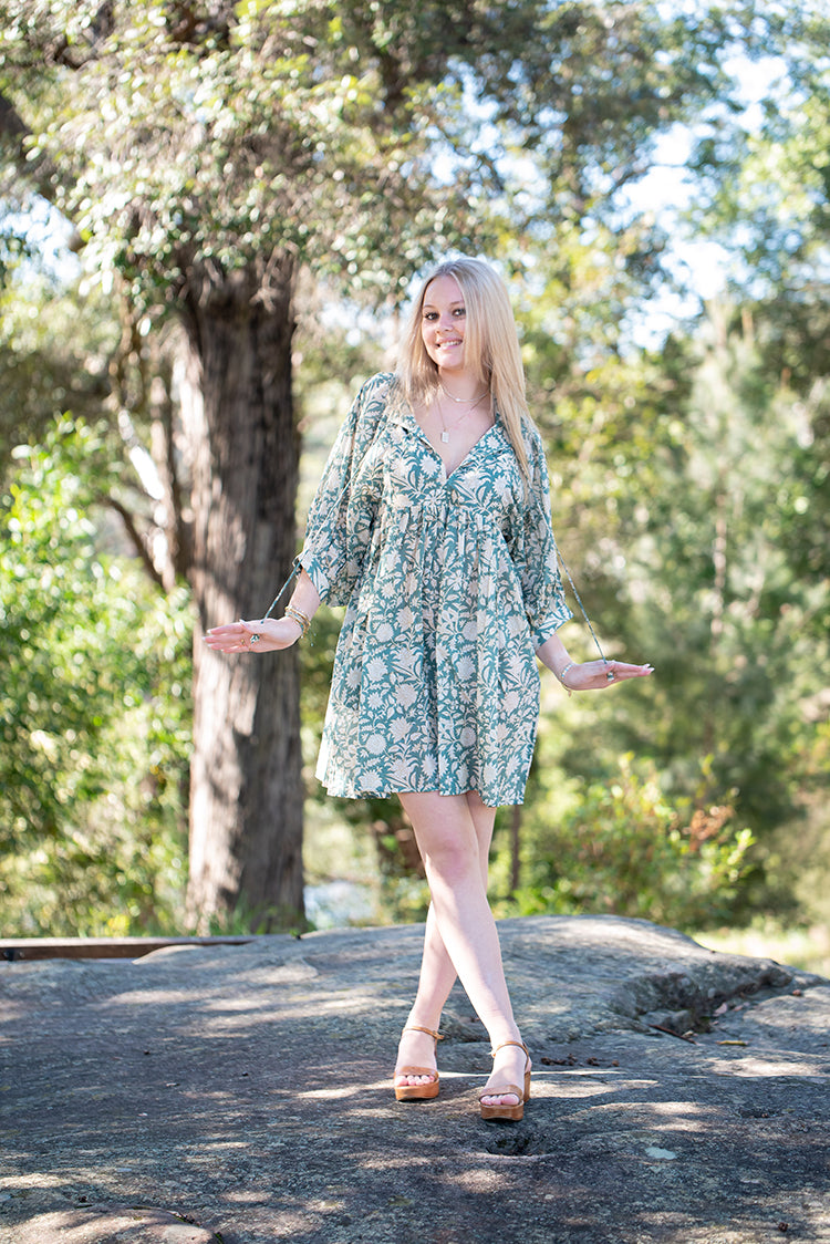 Our Sara Mini Dress is lightweight, flowy and designed for comfort. Featuring a floral hand block printed pattern on olive green colourway.